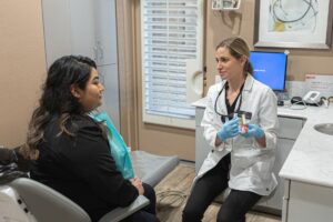 Dentist explaining dental implant treatment options during consultation